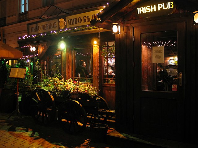 the lamplit front of an irish pub at night